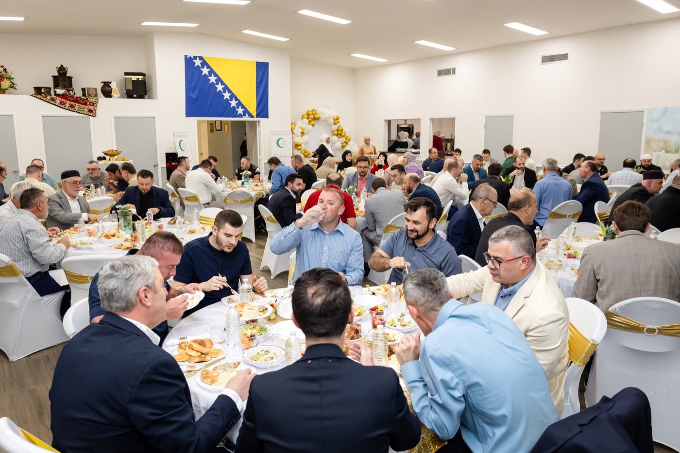 Guests seated at round tables during the anniversary dinner