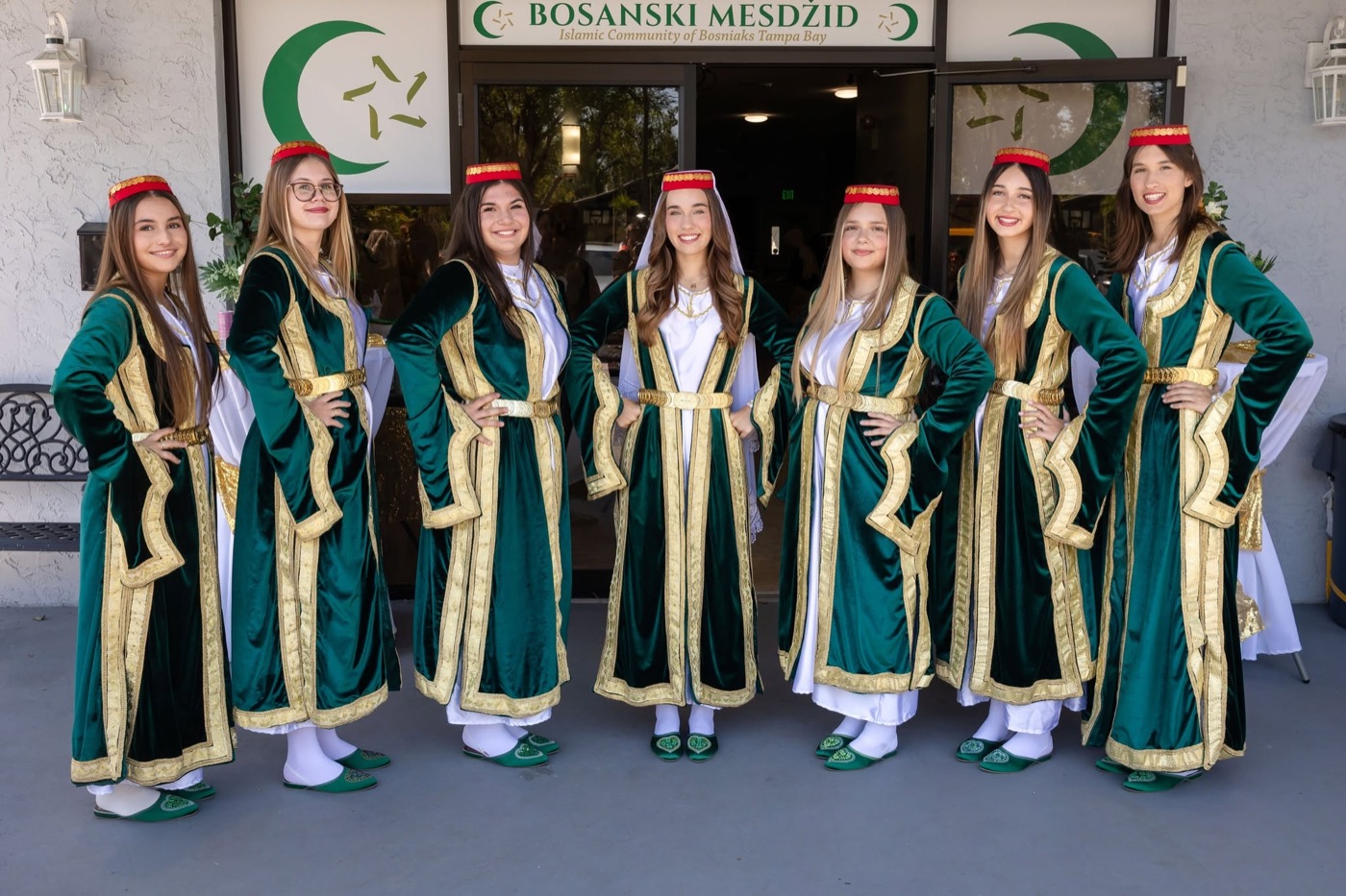Young women in traditional dress standing together in the mosque