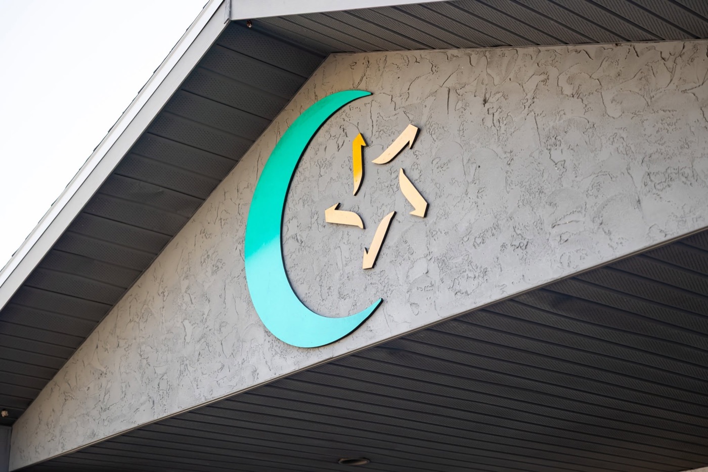 The crescent and star on the front of the mosque building